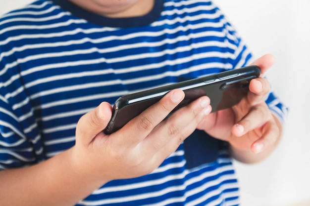 asian kids play games on their smartphones 42128 589
